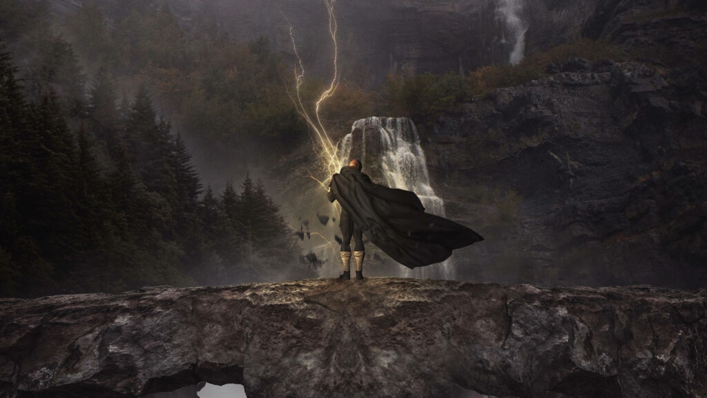 Black Adam on rugged cliff with lightning storm waterfall forest background wallpaper
