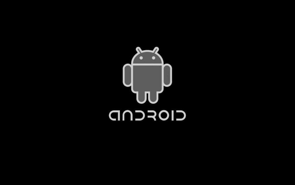 Merging Shades: A Captivating Black Android Emblem Set Against a Dimly Lit Black Backdrop Wallpaper