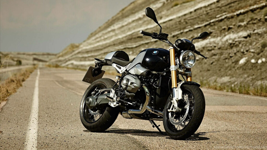 Graceful Black Beauty: BMW R Ninet Motorcycle Rests Majestically on an Abandoned Gray Road Wallpaper