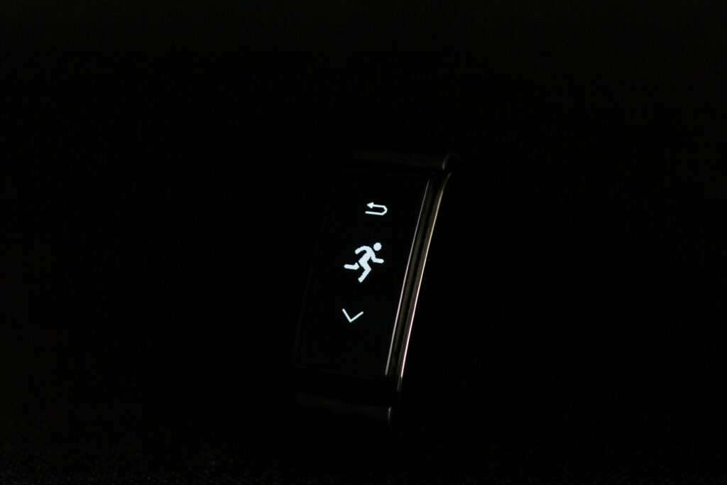 Stylish Running Companion: Sleek Smartwatch Against Night Sky Wallpaper