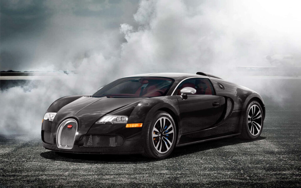 Black Bugatti Veyron on open road with dramatic smoke clouds showcasing sleek design wallpaper