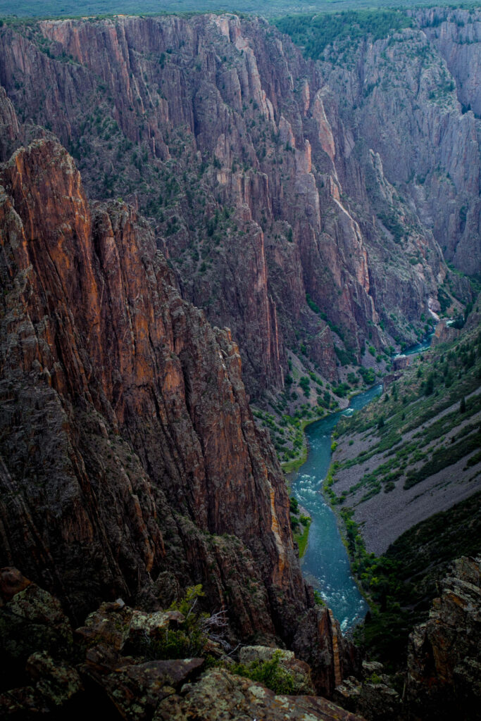 Black Canyon steep cliffs carved by emerald river showcasing rugged natural beauty wallpaper