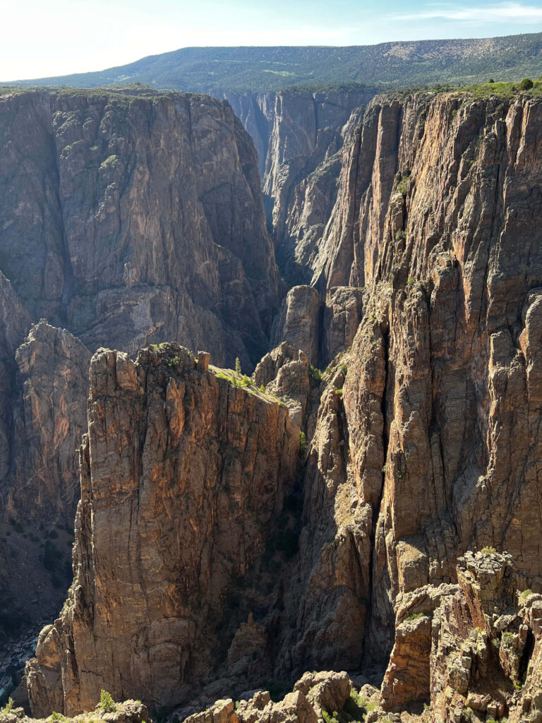 Breathtaking rugged Black Canyon cliffs and depths under sunlight natural wonder wallpaper background