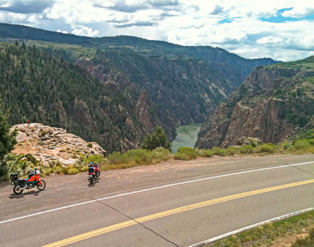 Black Canyon scenic wallpaper with dramatic cliffs winding river and motorcycles at overlook