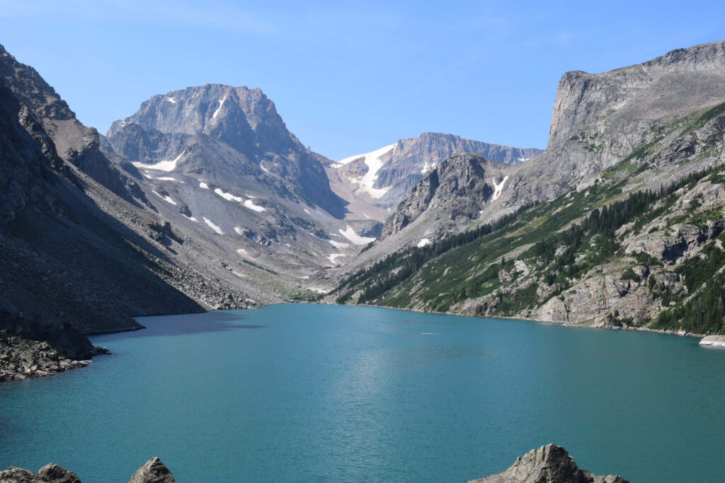 Black Canyon rugged mountains surround turquoise lake under clear blue sky scenic wallpaper background