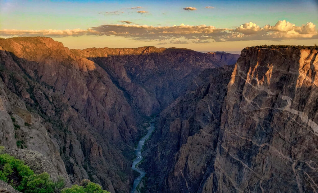 Black Canyon dramatic cliffs and winding river at vibrant sunset showcasing natural beauty wallpaper