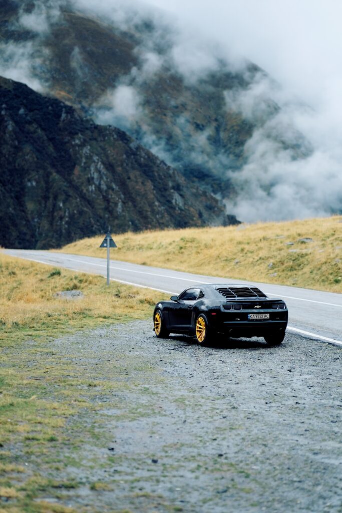 Sleek Black Chevelle Rear View Wallpaper with Misty Mountain Backdrop