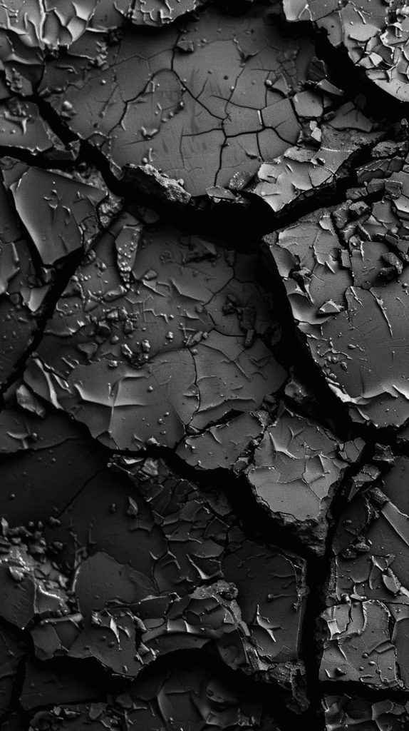 Black cracked desert texture macro shot high contrast dry fissures moody pure black wallpaper