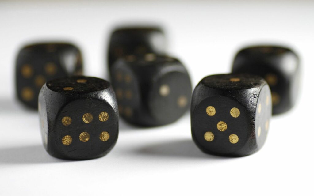 Vibrant Black Dice with Yellow Points - Smooth Texture Wallpaper