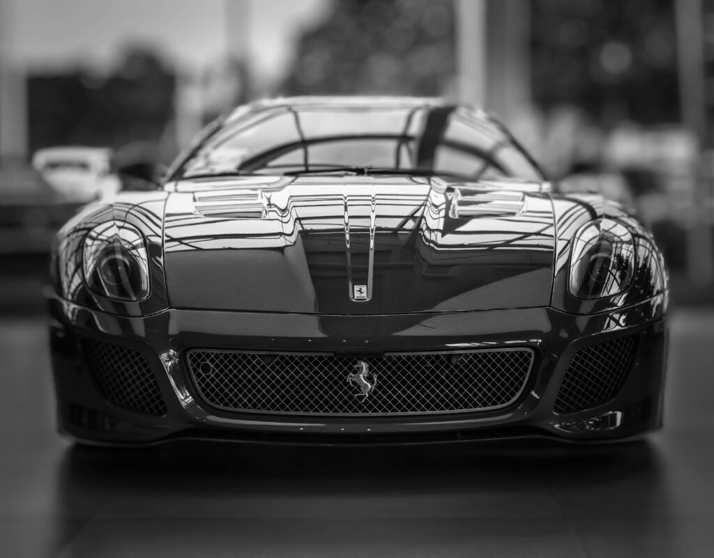 Front view of black Ferrari 599 GTO with aggressive styling sleek curves luxury sports car showroom Wallpaper