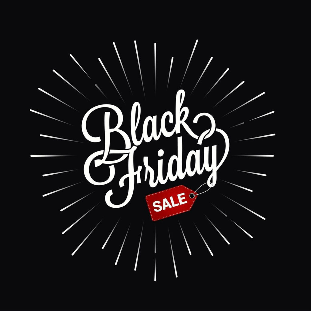 Black Friday cursive white text with red sale tag on dark background and glowing light rays Wallpaper