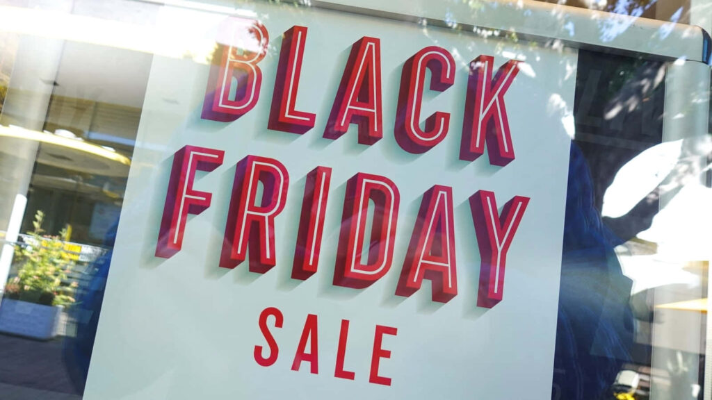 Black Friday Sale sign in store window promoting special deals and discounts wallpaper background
