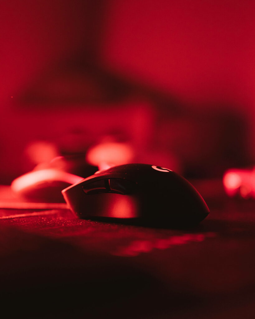 Sleek Black Gaming Mouse Illuminated by Vibrant Red Lights Wallpaper