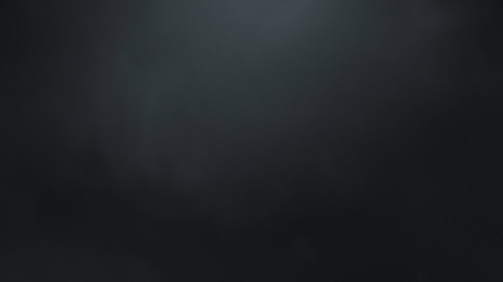 Minimalist black wallpaper with diagonal texture and soft gradient lighting for professional desktops