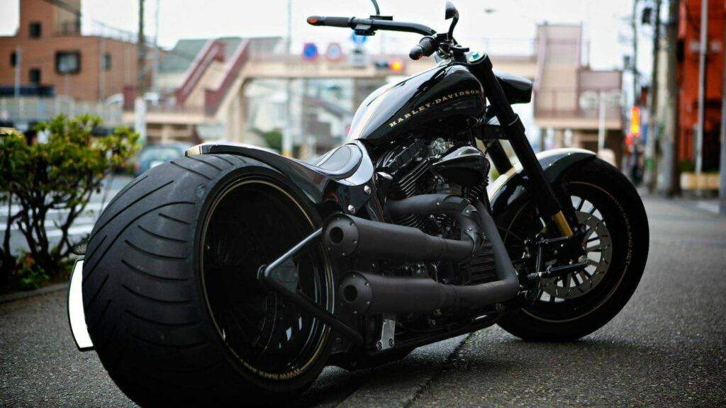 Roaring Beauty: The Onyx Harley-Davidson Chopper Motorcycle in HD Wallpaper Background