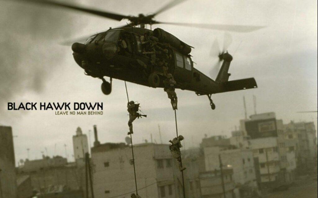 Black Hawk helicopter hovering over city with soldiers rappelling during urban military operation Wallpaper