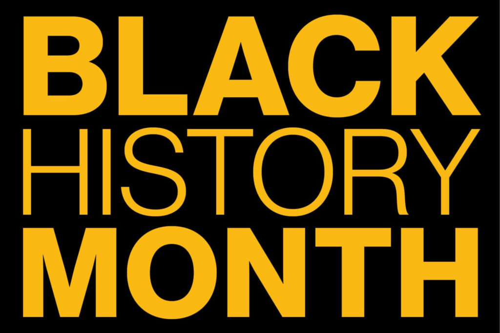 Black History Month bold yellow text on black background honoring Black heritage and culture Wallpaper