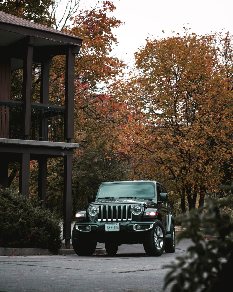 Black Jeep Wrangler: Rugged SUV Amidst Autumn Foliage Wallpaper