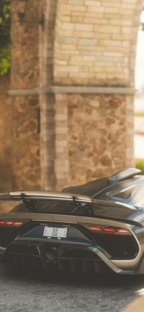 “Elegant Black Lamborghini Sesto Elemento Against Rustic Stone Backdrop” Wallpaper