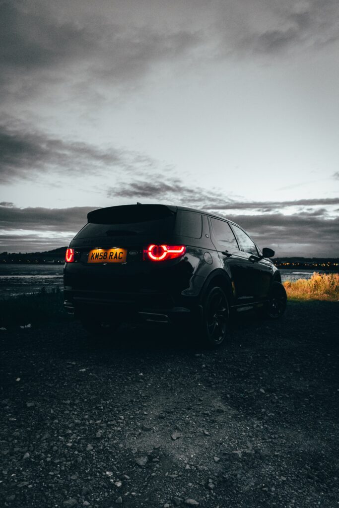 Black Land Rover Discovery 3 Rear View Wallpaper with Moody Sky