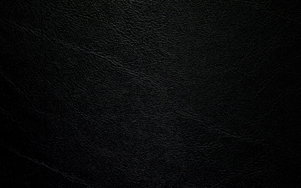 Close-up of premium black leather texture 4K wallpaper with sleek grain and dark background