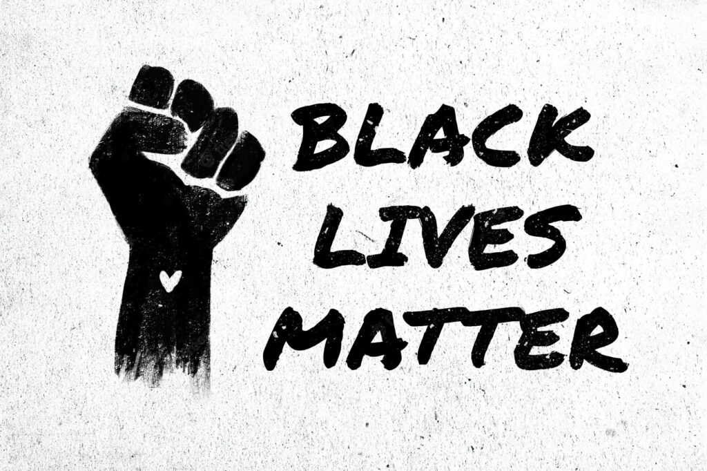 Raised fist with heart and bold Black Lives Matter text symbolizing unity and racial justice wallpaper
