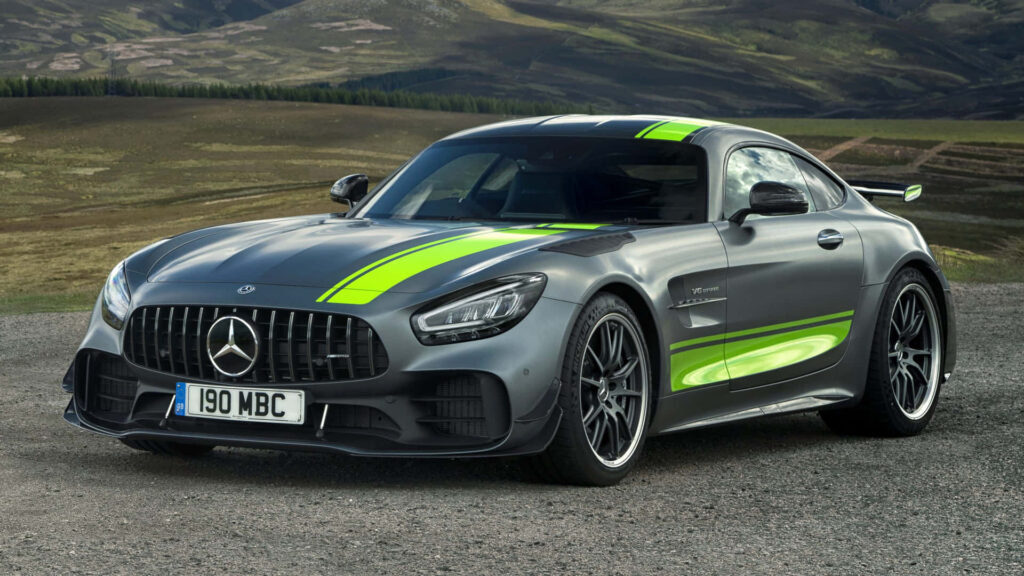 Black Mercedes Benz AMG GT R Pro parked on scenic hills with dramatic cloudy sky background Wallpaper