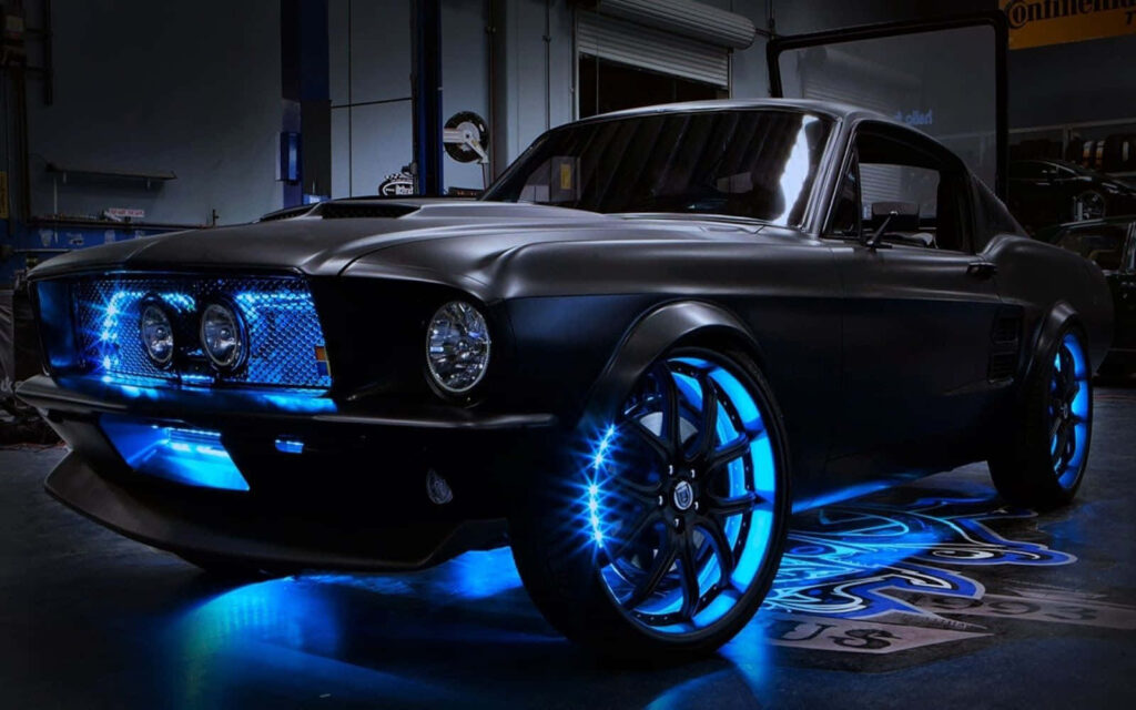 Sleek black muscle car with blue LED lights and modern wheels in professional garage wallpaper