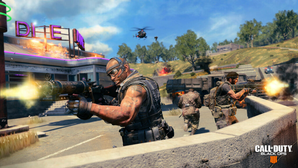 Deadly Squad Ignites Chaos: Epic COD Black Ops 4 Wallpaper Unleashes Intense Action Amid a Fiery Diner Siege with Helicopters on the Horizon
