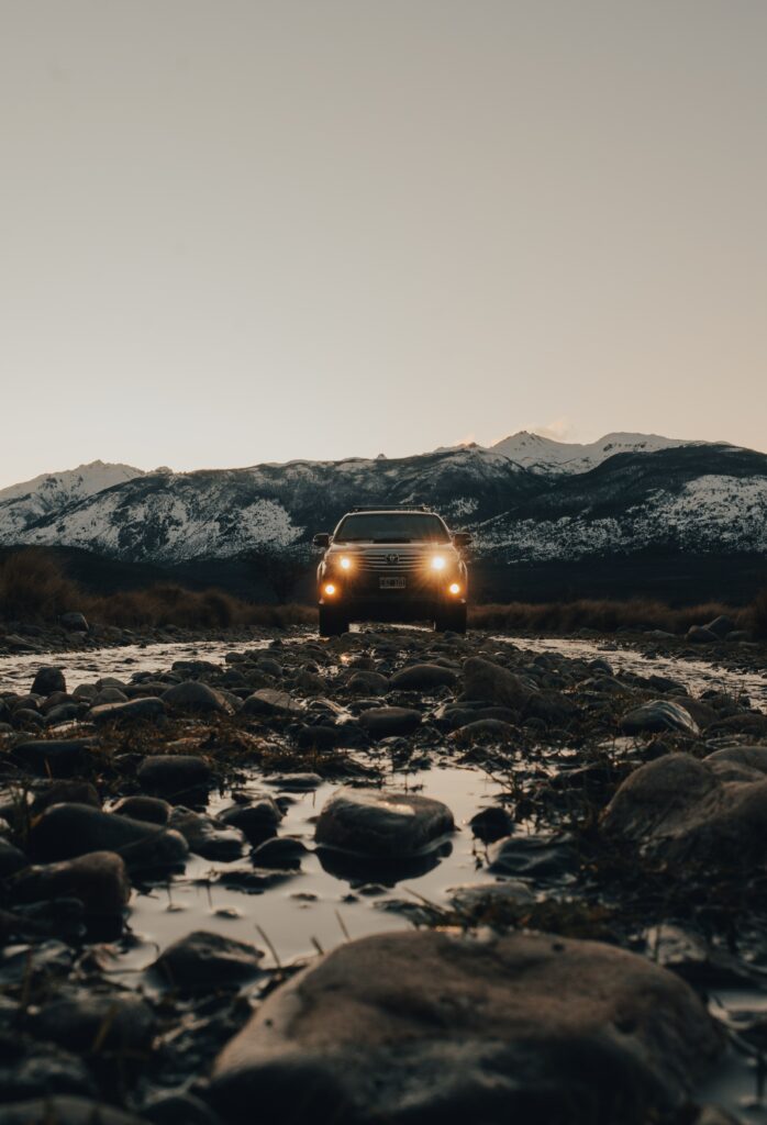 Black SUV Adventure Wallpaper with Snow-Capped Mountain Landscape