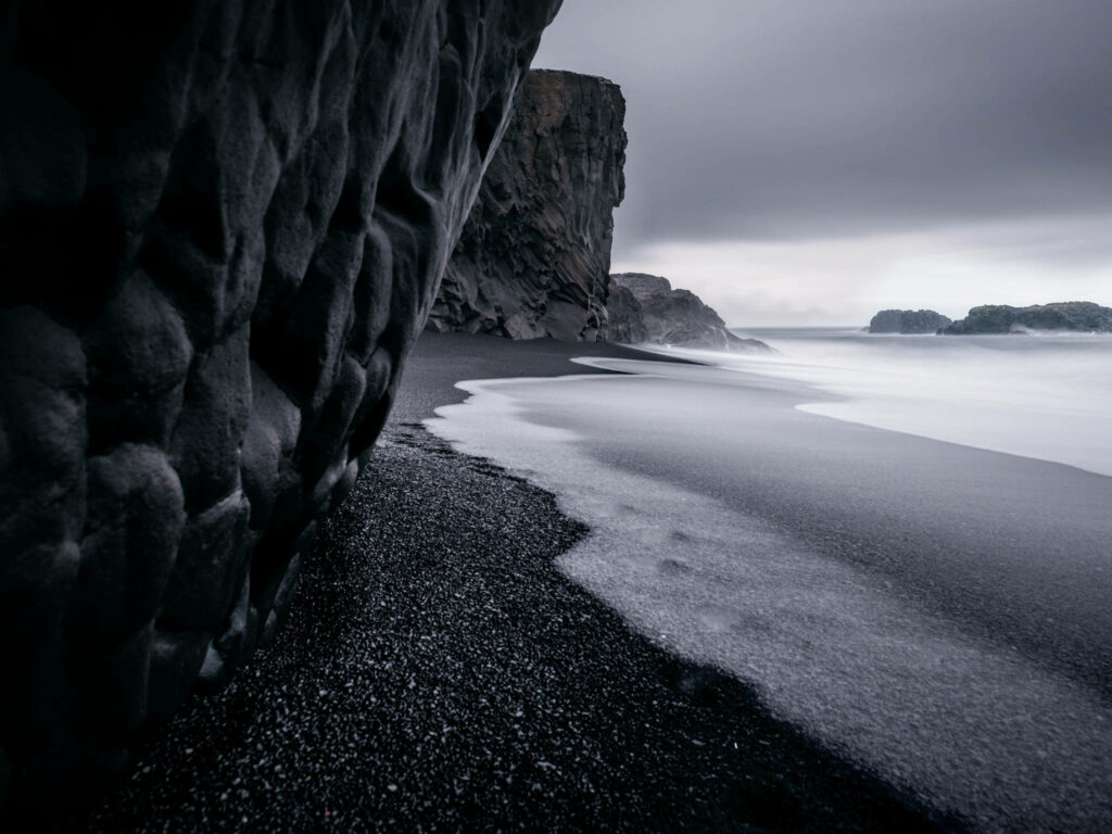 Moody Black Sand Coastline Wallpaper - Dramatic Nature Background