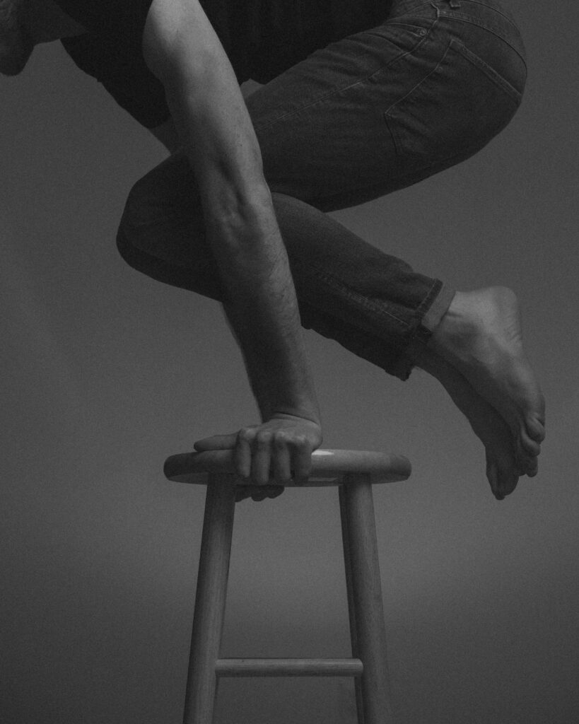 Black and White Balance Exercise: Strength and Control with a Stool Wallpaper