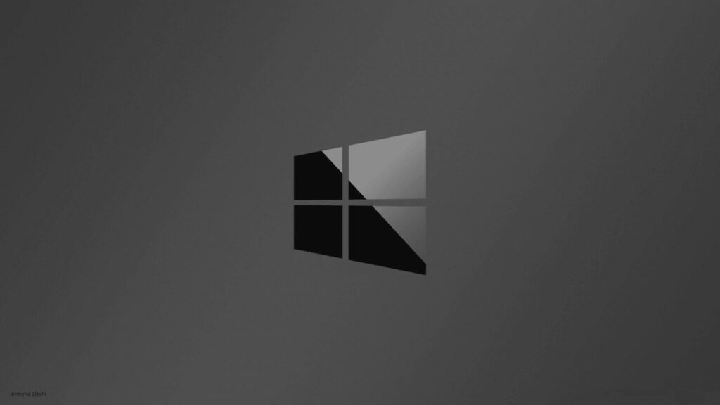 Sleek and Stylish: A High-Definition Display of the Dazzling Black Windows 10 Logo on a Vignette-Infused Gray Backdrop Wallpaper
