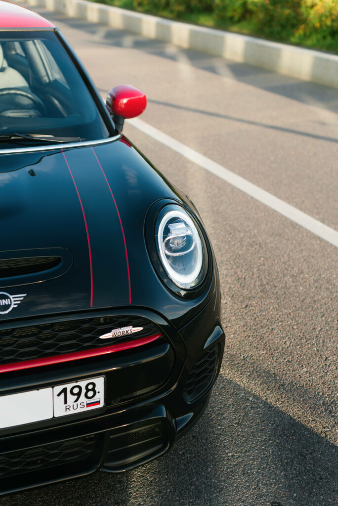 Stunning Black and Red Mini Cooper Wallpaper Background on Sunlit Road