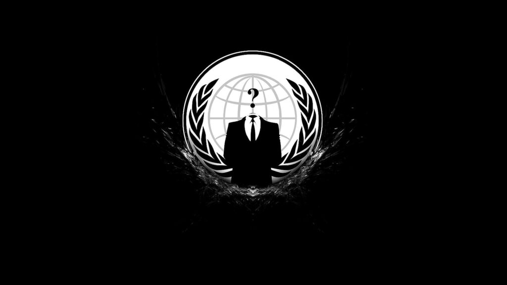 Rebel in Monochrome: Anonymous Hacker Wallpaper with Iconic Black Logo on Dark Background