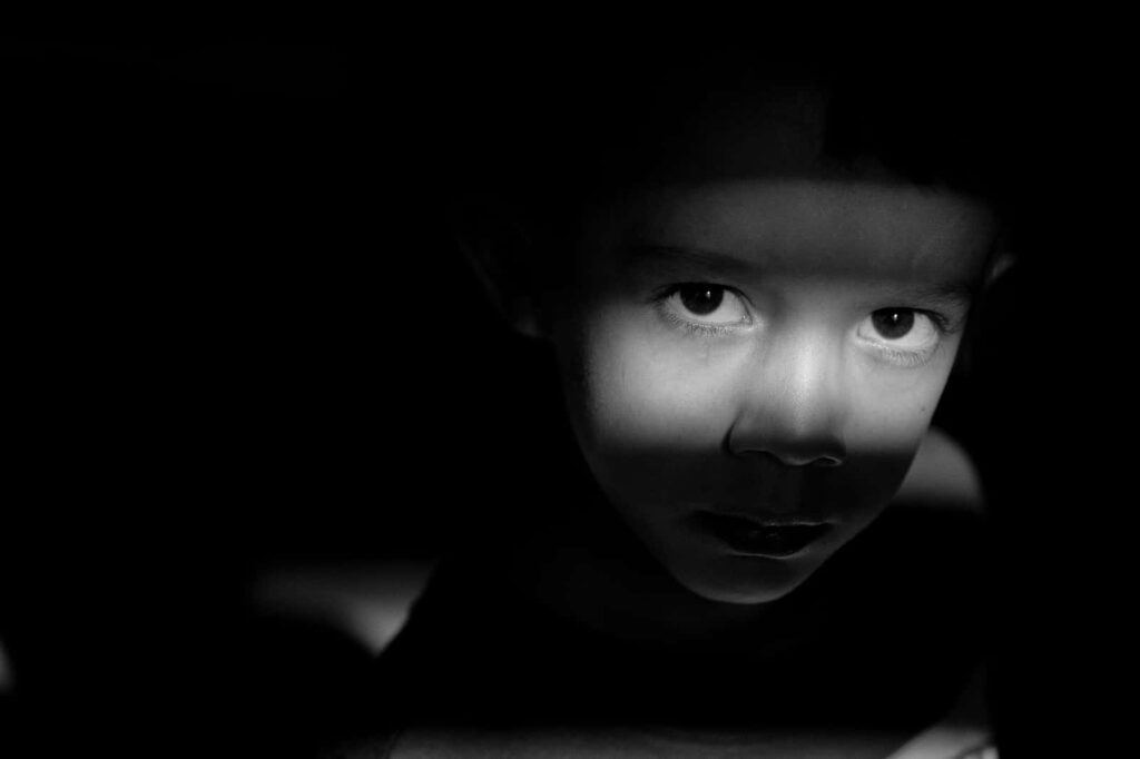 Child's Face Portrait: Dramatic Black-and-White Wallpaper Background