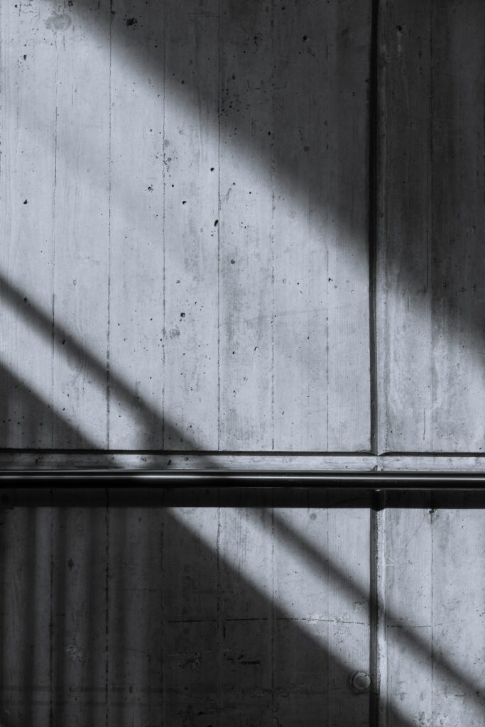 Dramatic Black and White Concrete Wall Wallpaper with Shadow Patterns