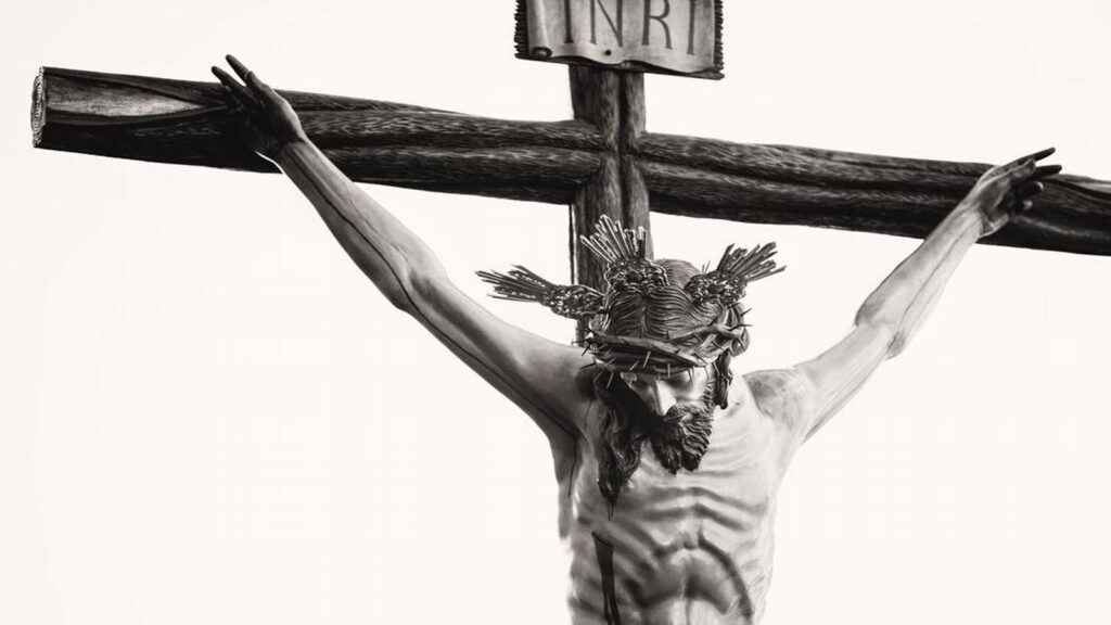 Divinely Sacrificed: A Monochromatic Wallpaper of the Crucifixion in Christianity