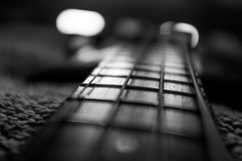 Close-Up Black and White Guitar Fretboard Wallpaper with Depth
