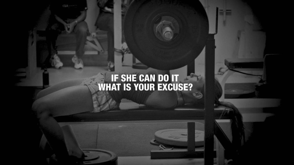 Woman focused heavy bench press black white gym wallpaper motivation quote daily training