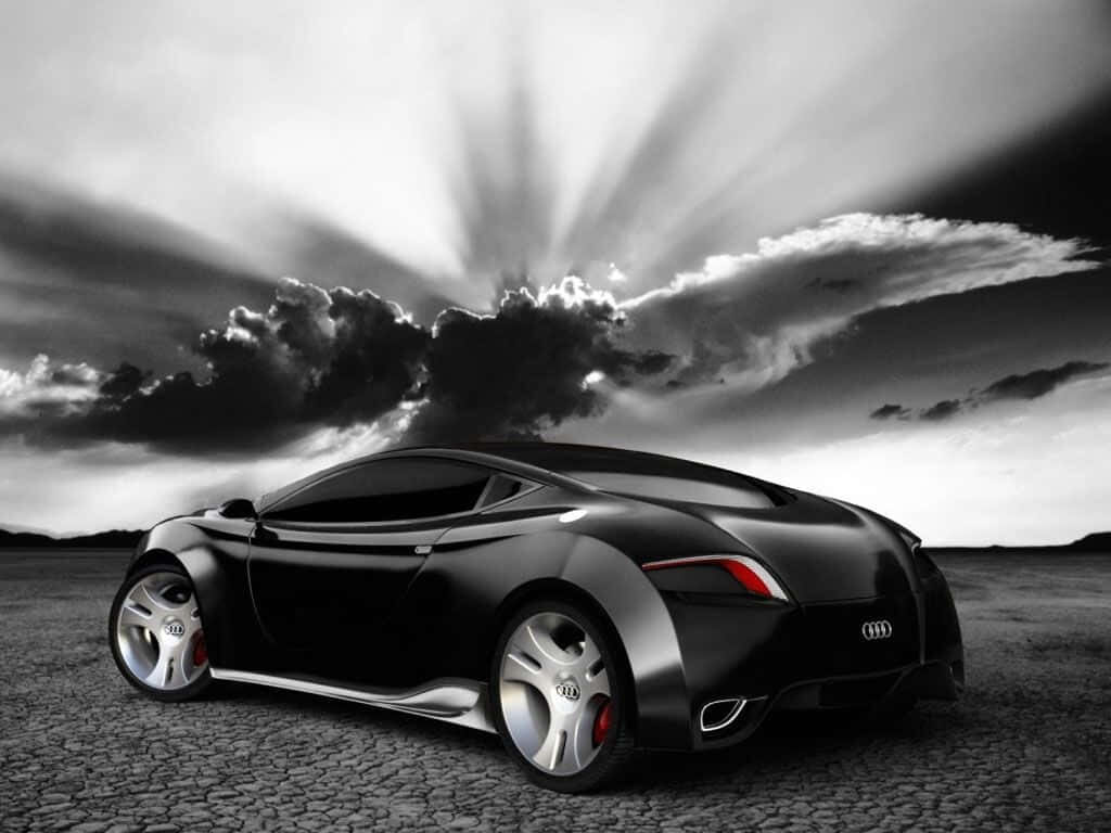 Black and white sports car wallpaper rugged landscape dramatic cloudy sky background image