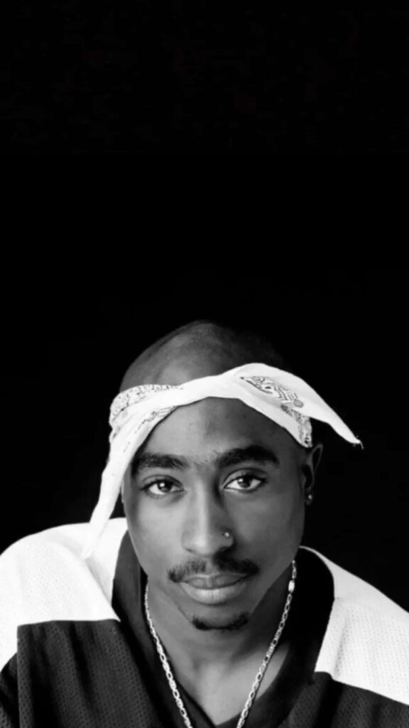 Iconic Portrayal: Vintage Monochrome Snapshot Showcasing Tupac Shakur Against a Dark Canvas Wallpaper