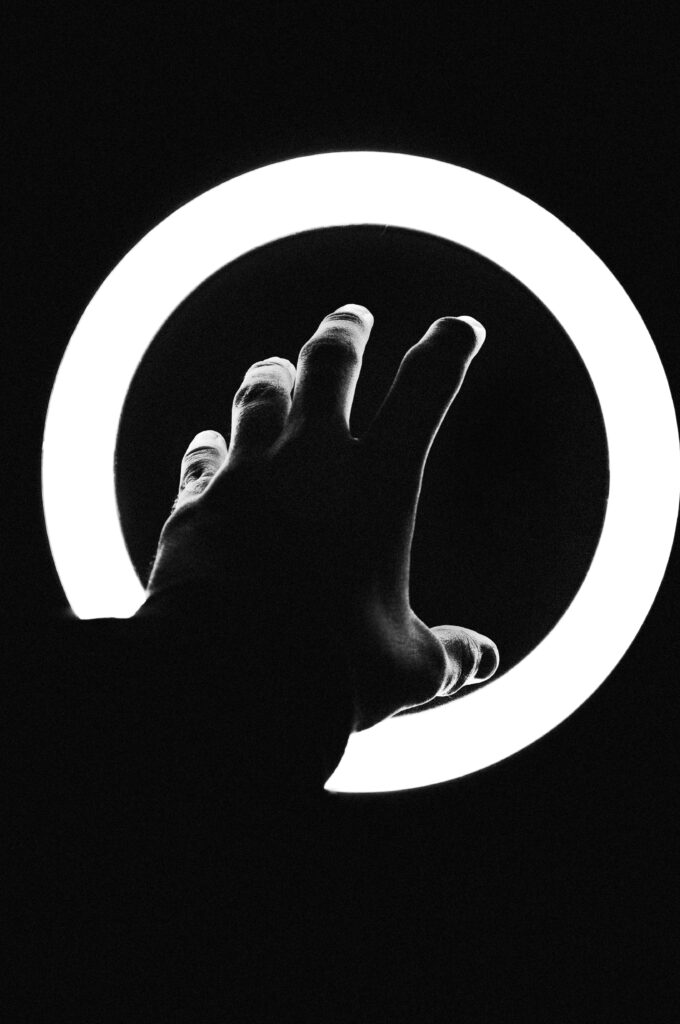 Striking Black and White Wallpaper: Hand Reaching for Light