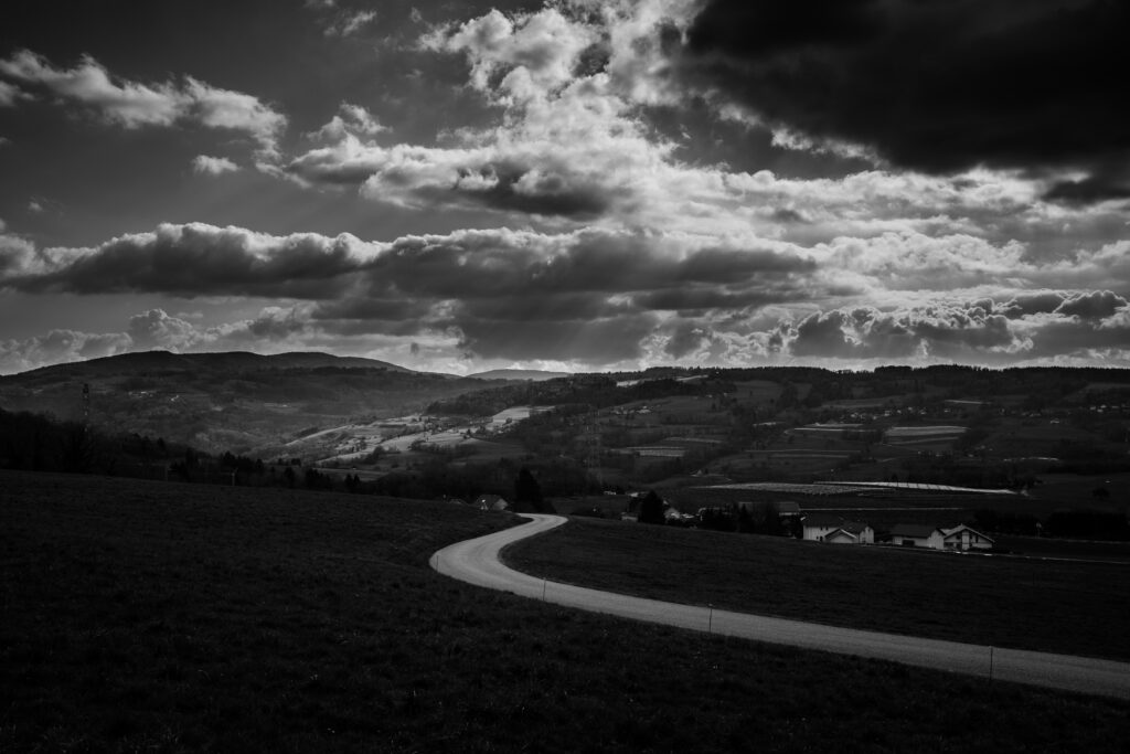 Winding Road Black and White Wallpaper - Dramatic Rural Landscape