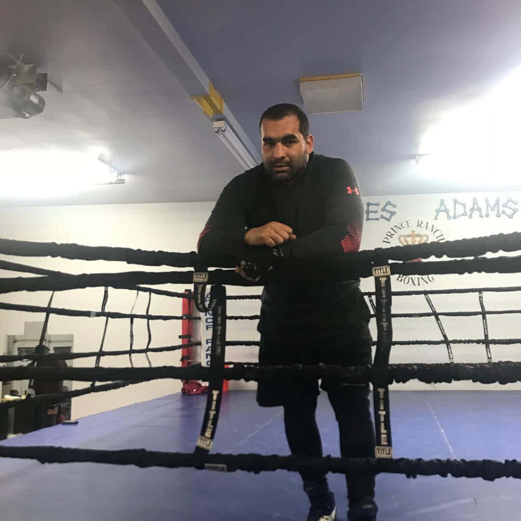 Blagoy Ivanov focused in boxing gym leaning on ropes during intense training session wallpaper