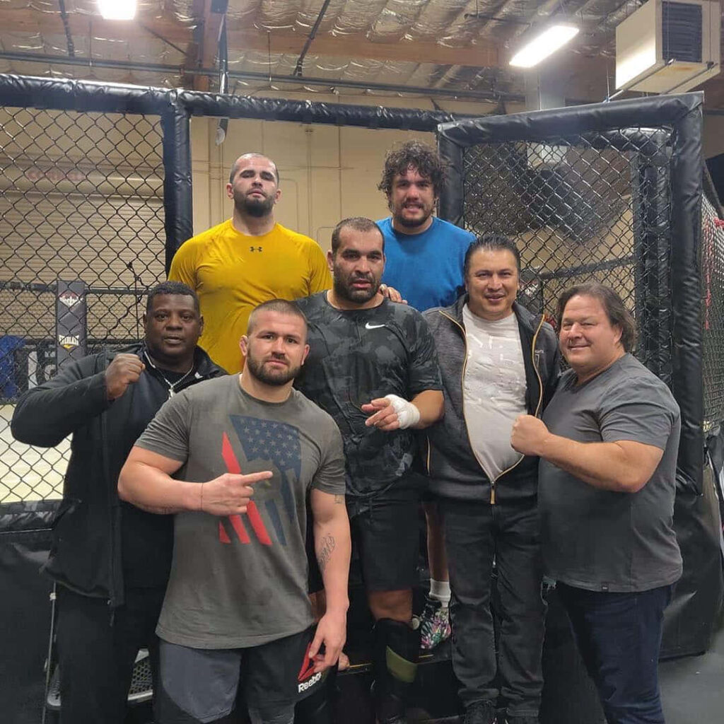 Blagoy Ivanov with gym friends inside MMA training facility after workout session wallpaper background