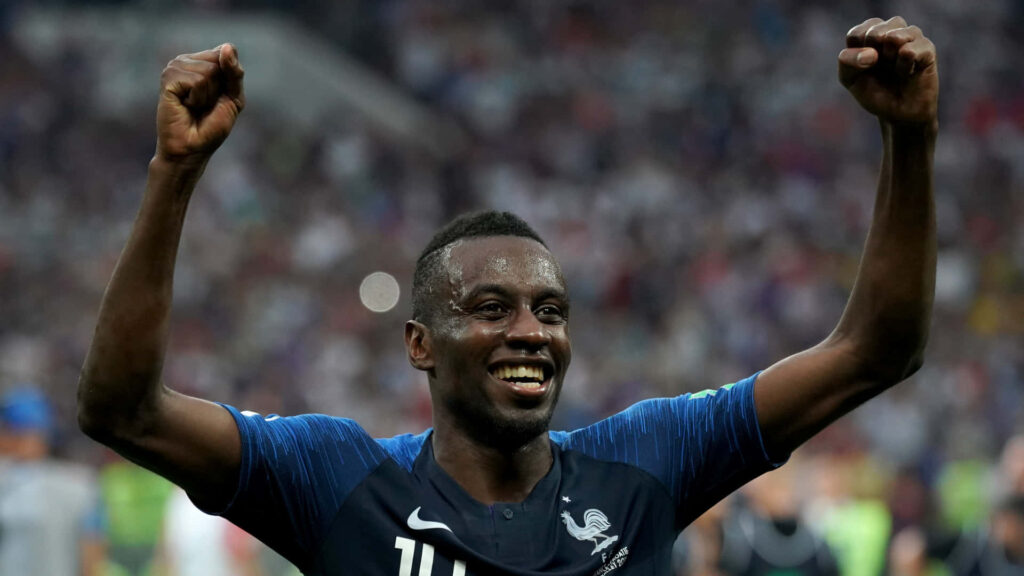 French footballer Blaise Matuidi celebrating victory with raised arms on the field wallpaper background