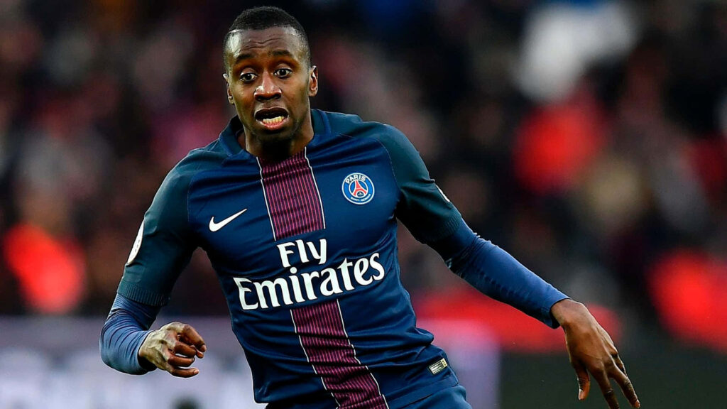 PSG midfielder Blaise Matuidi running in blue red kit during intense football match wallpaper