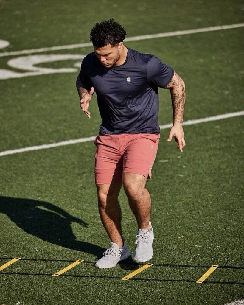 Blake Corum agility drills intense football training session showcasing athleticism and dedication Wallpaper