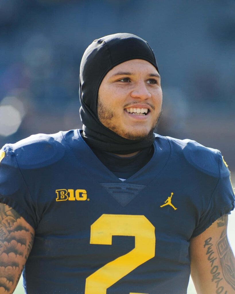 Blake Corum smiling in football uniform wearing number 2 jersey vibrant wallpaper background